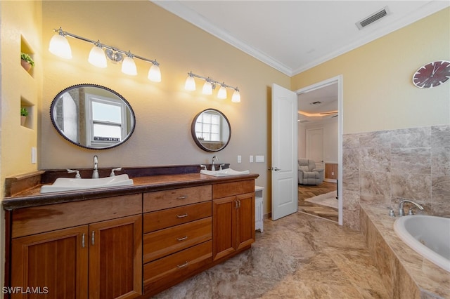 bathroom featuring vanity, tiled bath, a wealth of natural light, and ornamental molding