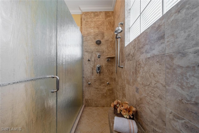 bathroom featuring a shower with door and crown molding