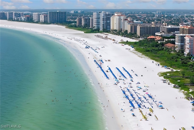 drone / aerial view featuring a water view and a beach view