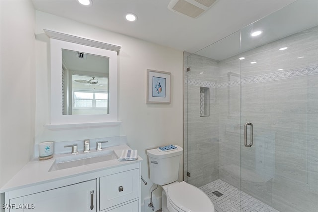 bathroom with vanity, toilet, walk in shower, and ceiling fan