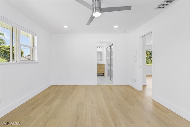 spare room with ceiling fan and light hardwood / wood-style floors