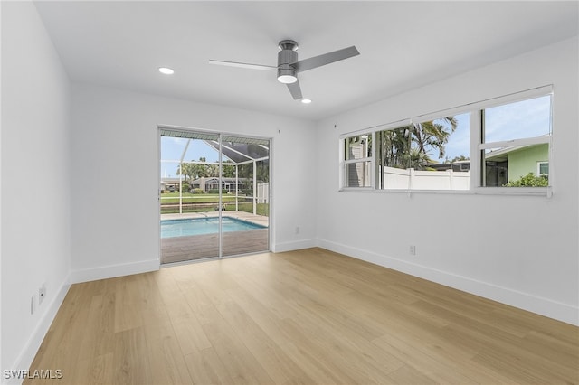 empty room featuring ceiling fan and light hardwood / wood-style floors