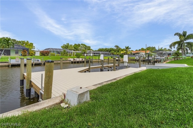 dock area featuring a water view and a yard