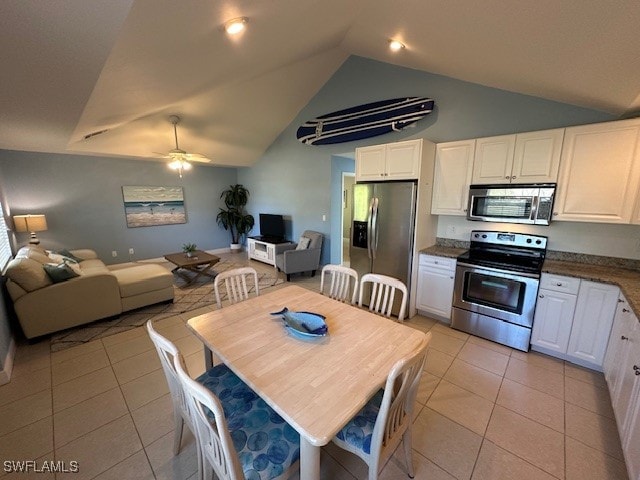 kitchen featuring white cabinetry, stainless steel appliances, and vaulted ceiling