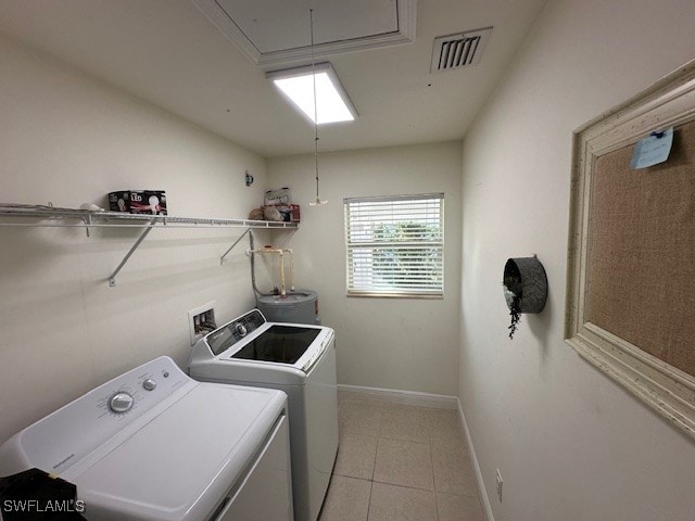 laundry room with washing machine and dryer and light tile patterned floors