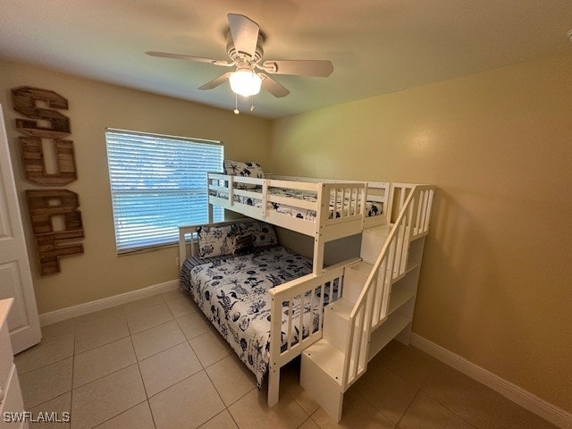 tiled bedroom featuring ceiling fan