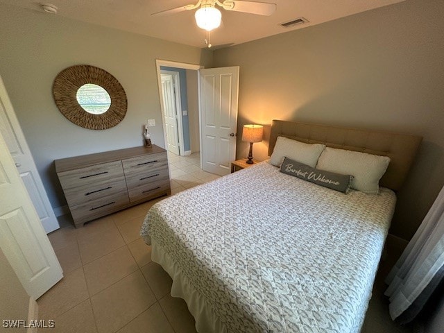 bedroom featuring light tile patterned floors and ceiling fan