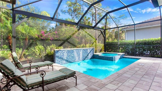 view of swimming pool featuring a lanai, an in ground hot tub, and a patio