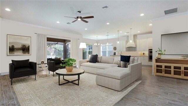 living room featuring ceiling fan with notable chandelier and ornamental molding