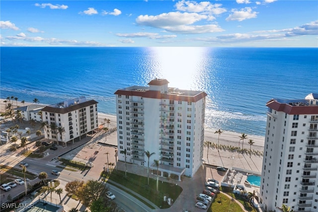 bird's eye view with a water view and a beach view