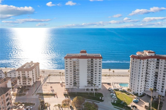 bird's eye view with a water view and a beach view