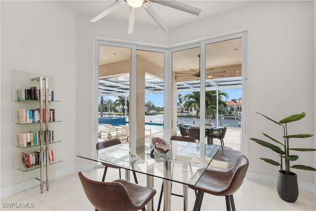 tiled dining area featuring a wealth of natural light and a water view