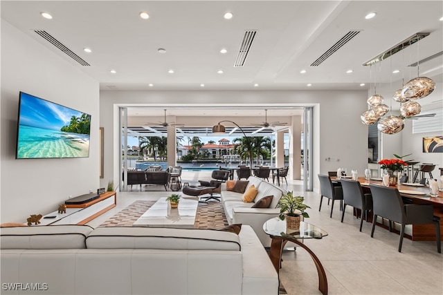 tiled living room with ceiling fan