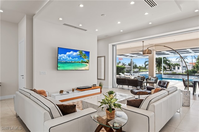 living room with ceiling fan and light tile patterned floors