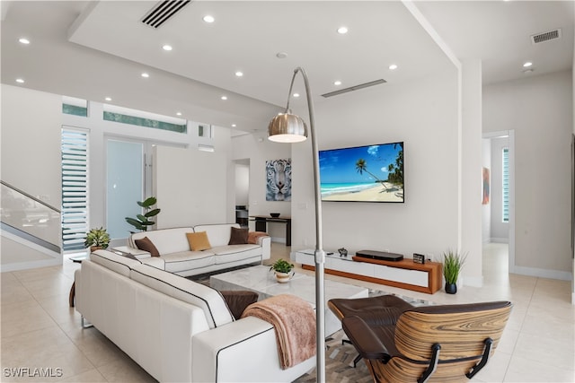 living room with plenty of natural light and light tile patterned floors