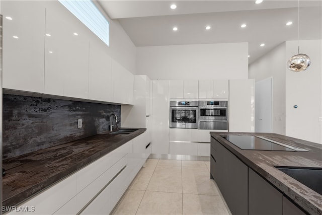 kitchen with white cabinets, sink, decorative backsplash, black electric cooktop, and light tile patterned floors