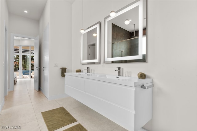 bathroom featuring tile patterned flooring, vanity, and an enclosed shower