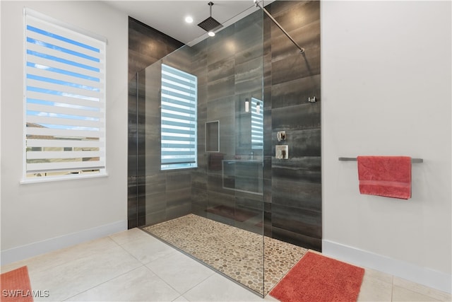 bathroom with tile patterned floors and tiled shower