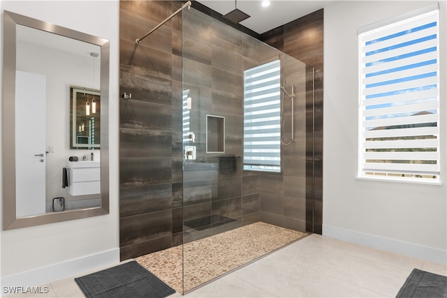 bathroom with tile patterned flooring and tiled shower