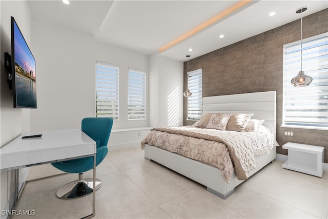 tiled bedroom with multiple windows and tile walls