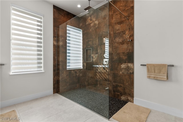 bathroom with tile patterned floors and tiled shower