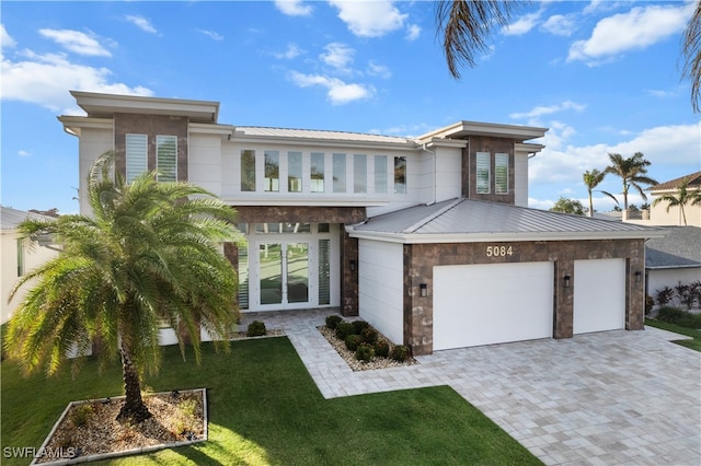 view of front of house with a front lawn and a garage