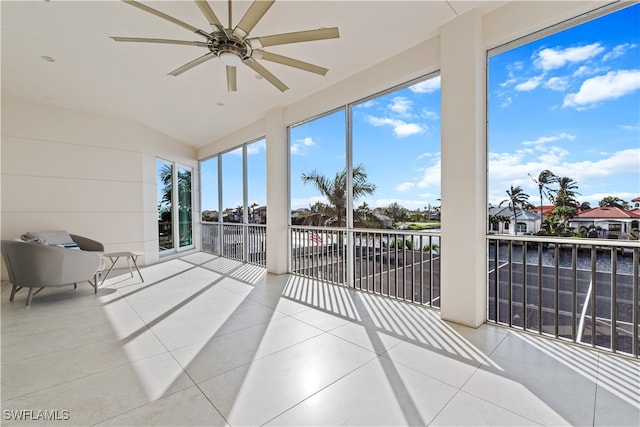 sunroom / solarium featuring ceiling fan