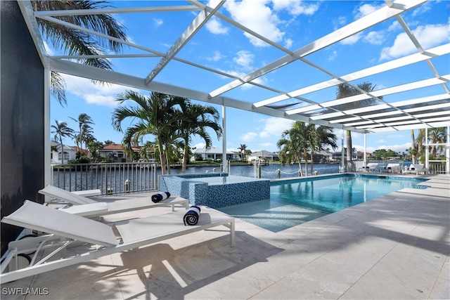 view of swimming pool with an in ground hot tub, a water view, glass enclosure, and a patio area