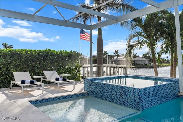 view of pool with a water view and a patio area