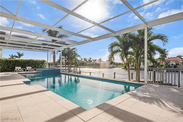 view of swimming pool with a lanai, a patio area, and a water view