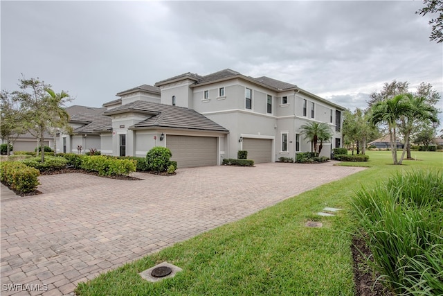 view of front of home with a garage and a front lawn