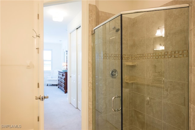 bathroom featuring a shower with shower door