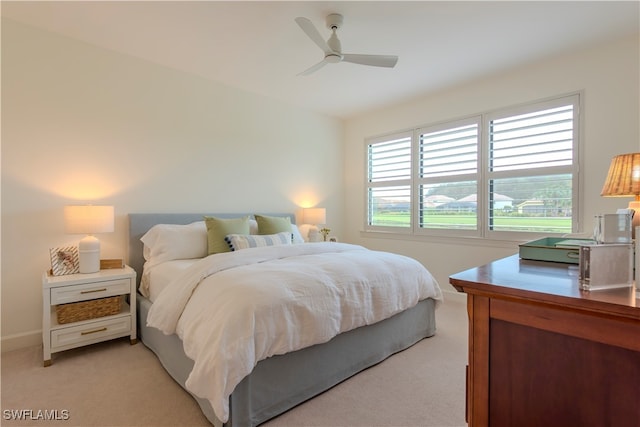 bedroom with ceiling fan and light carpet