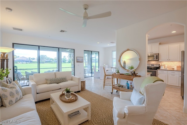 living room featuring ceiling fan and light tile patterned floors