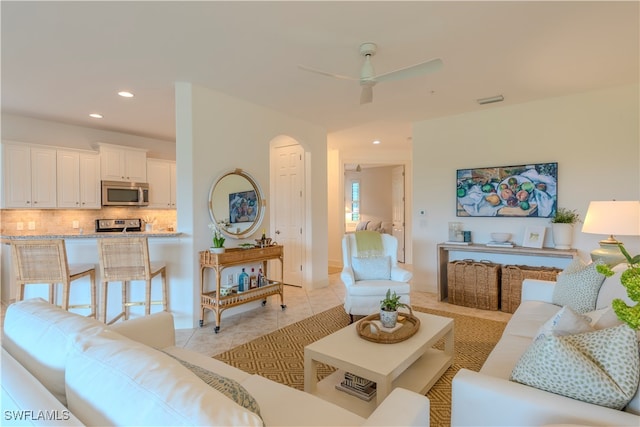 tiled living room featuring a wealth of natural light and ceiling fan