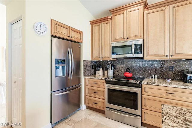 kitchen with decorative backsplash, light brown cabinets, stainless steel appliances, and light stone countertops