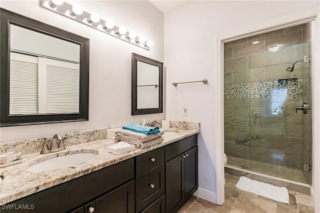 bathroom featuring vanity, toilet, and an enclosed shower