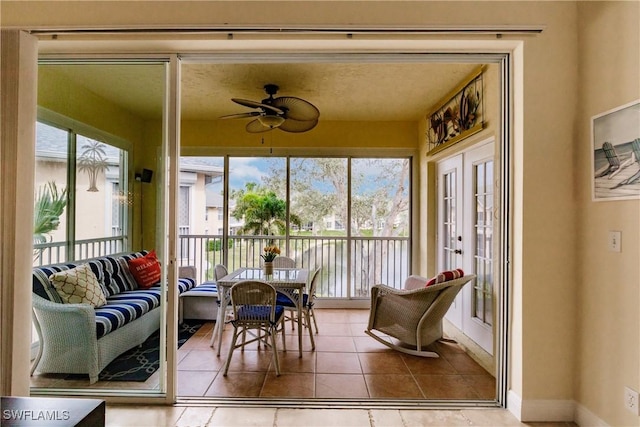 sunroom with ceiling fan and french doors