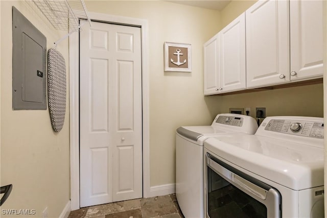 laundry room featuring cabinets, electric panel, and separate washer and dryer