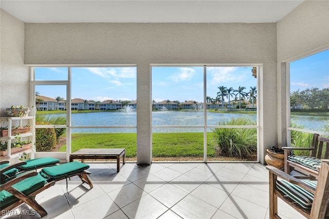 sunroom / solarium featuring a wealth of natural light and a water view