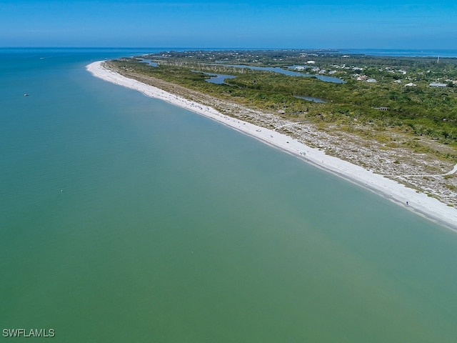 bird's eye view featuring a water view and a view of the beach