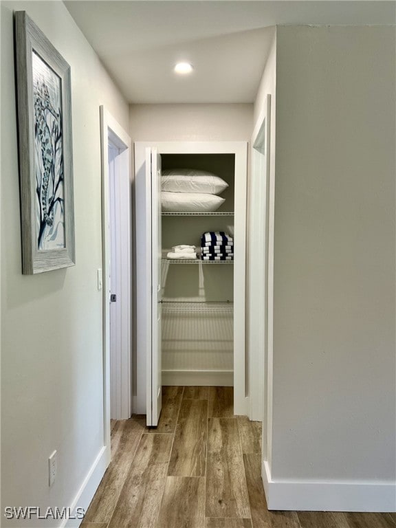 corridor with light hardwood / wood-style floors