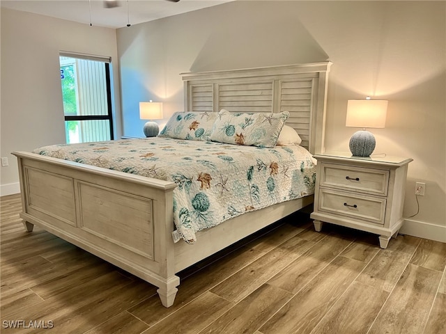 bedroom with hardwood / wood-style flooring