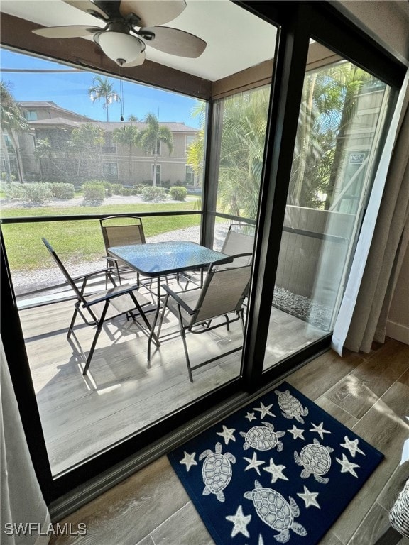 sunroom / solarium featuring ceiling fan