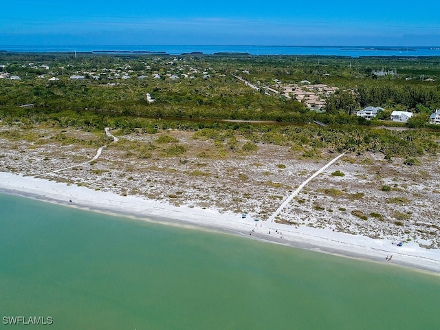 bird's eye view featuring a view of the beach and a water view