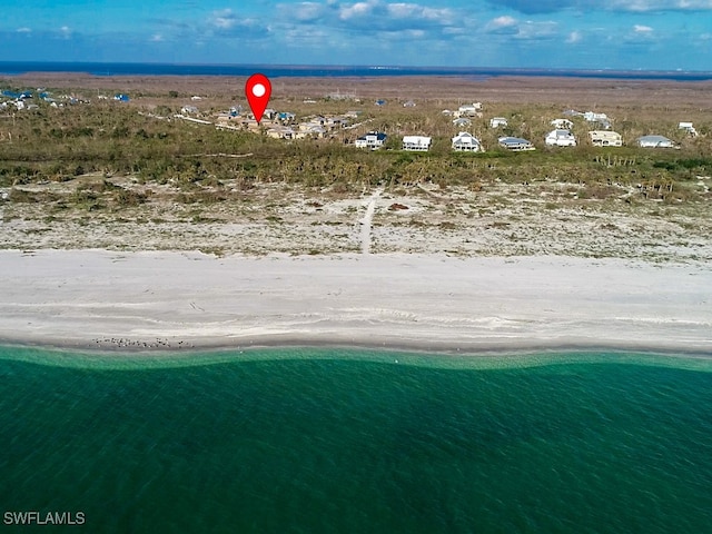 bird's eye view featuring a water view and a beach view