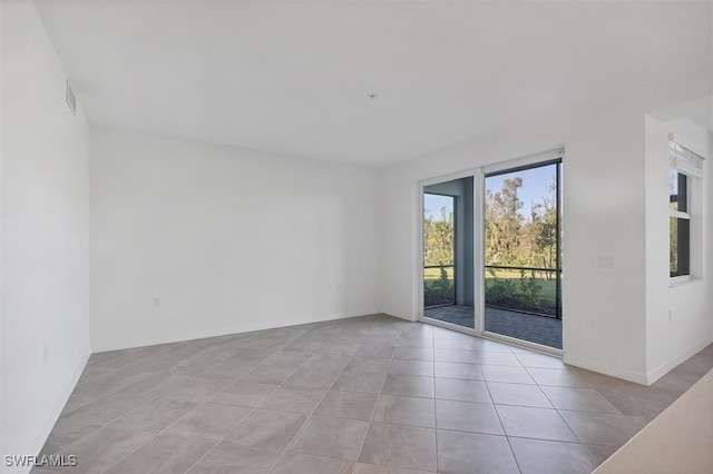 spare room featuring light tile patterned flooring