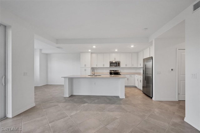 kitchen featuring stainless steel appliances, sink, a center island with sink, white cabinetry, and light tile patterned flooring