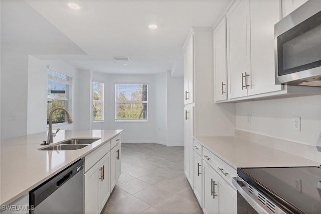 kitchen with white cabinets, sink, and stainless steel appliances