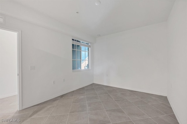 empty room with light tile patterned floors